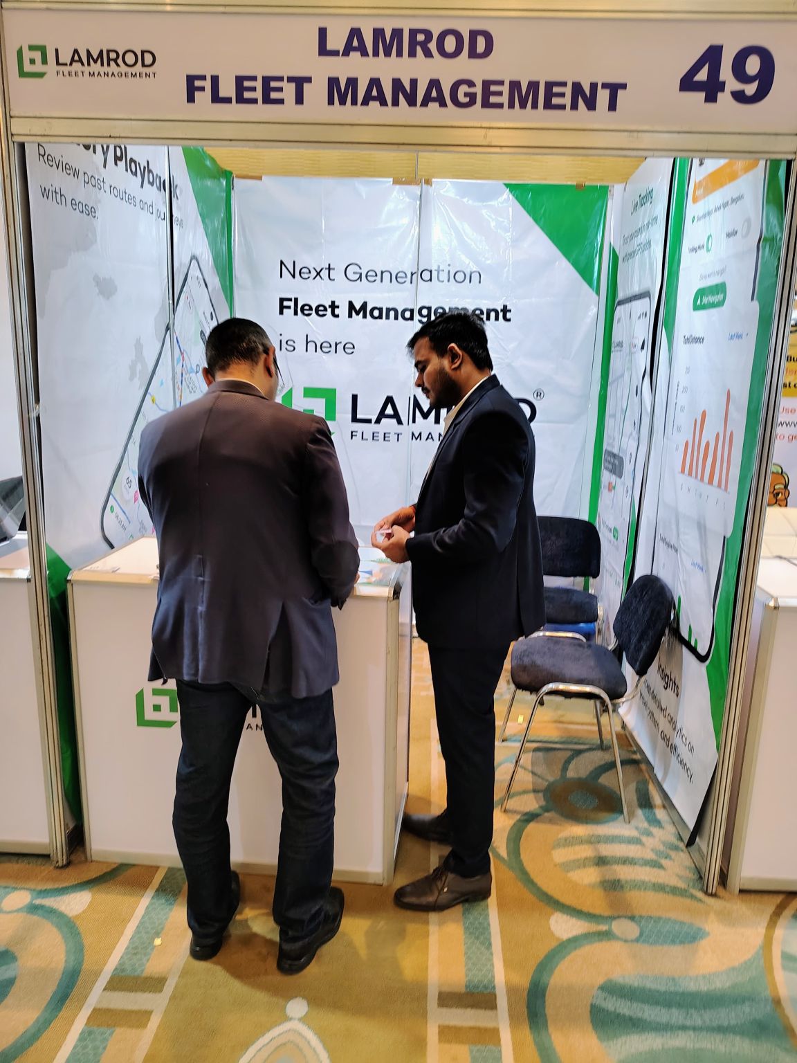 Visitor reviewing the Lamrod Fleet Management app at the India-Africa ICT Expo booth in Cairo